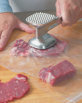 To flatten the steaks easily and avoid splatter, place the meat between pieces of plastic wrap before pounding.