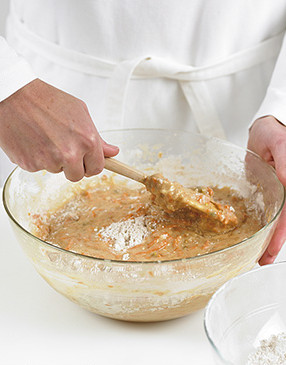 Fold the dry ingredients into the batter just until blended. Overmixing results in a cake with tunneling and a tough crumb.