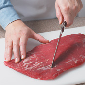 Using just the tip of a knife, make shallow cuts in a diamond pattern across the grain of the meat.