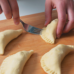 Fold pastry over the filling, press edges together, and crimp by pressing with a fork. 