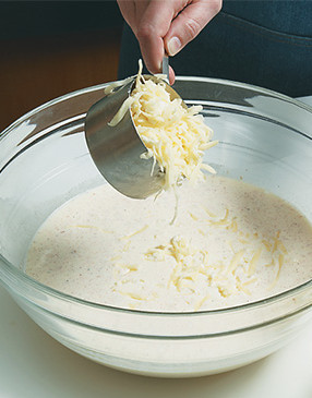 Stir half of the fontina and half of the mozzarella into the cream mixture to make a cheese sauce.