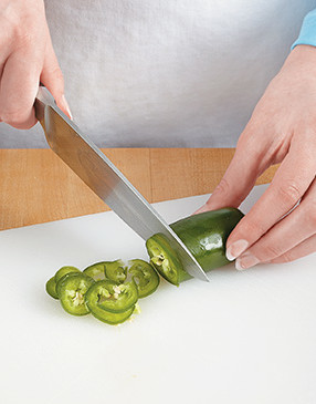 If you like spice, slice the jalape&ntilde;o. Otherwise, cut it in half lengthwise to remove all of the fiery seeds.