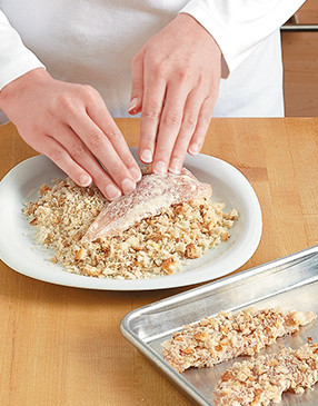 Firmly press both sides of the chicken into the almond and bread crumb mixture so the crumbs stick.