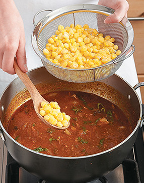 Since hominy is canned with lots of salt, be sure to drain and rinse it before stirring into the chili.