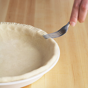 Crimp the edge of the pastry with a fork before blind-baking so that the leaves lie flat along the edge.