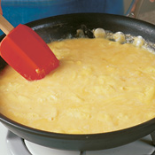 Wipe skillet clean after removing artichokes and prosciutto. Add eggs to skillet; stir and cook until curds form.