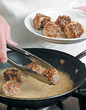 Return all of the meatballs to the skillet to finish cooking in the simmering sauce.