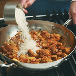 Add the rice to the chicken mixture and stir to coat with oil. Cook for 1 minute.