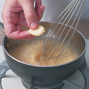 Whisk <em>beurre mani&eacute;</em> and thyme into simmering sauce. Heat and stir until sauce is slightly thickened.