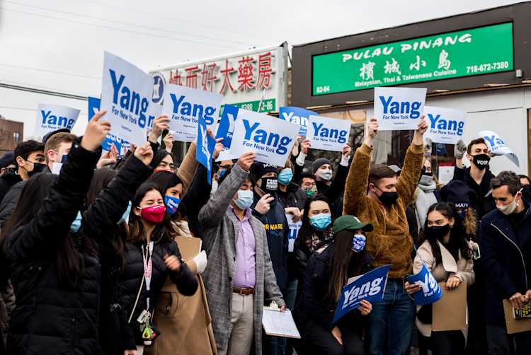 Yang supporters with signs