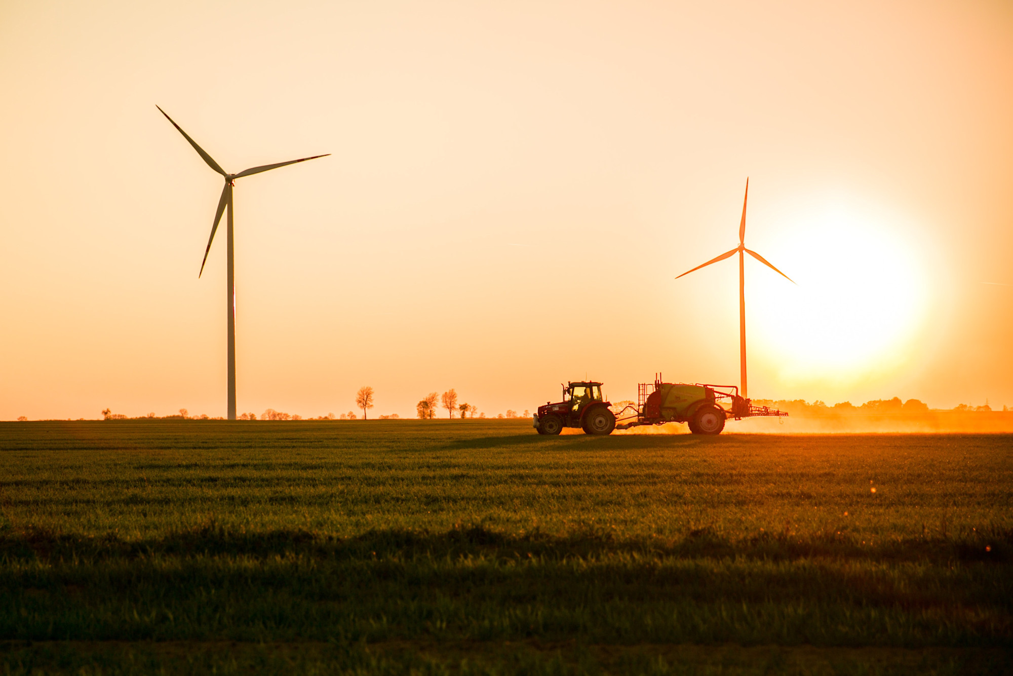 Tractor applying chem at sunset.