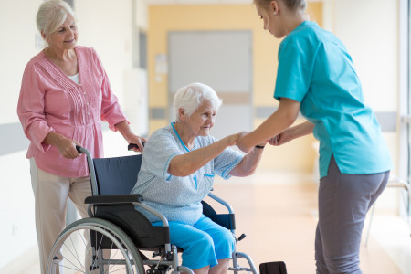nurse-helping-woman-in-wheelchair
