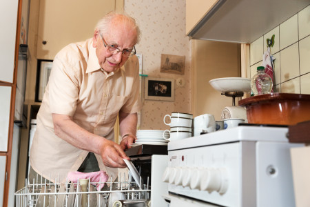 elderly-man-loading-dishwasher