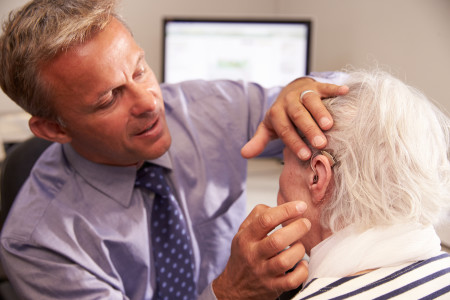 doctor-fitting-hearing-aid