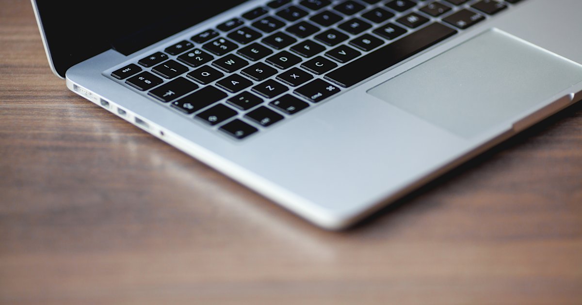 MacBook Pro computer on a wooden desk
