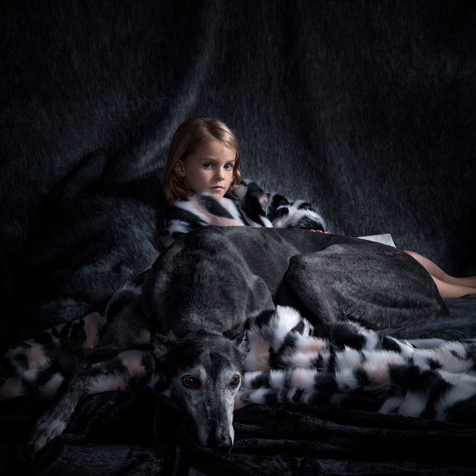 young girl in fur coat with dog