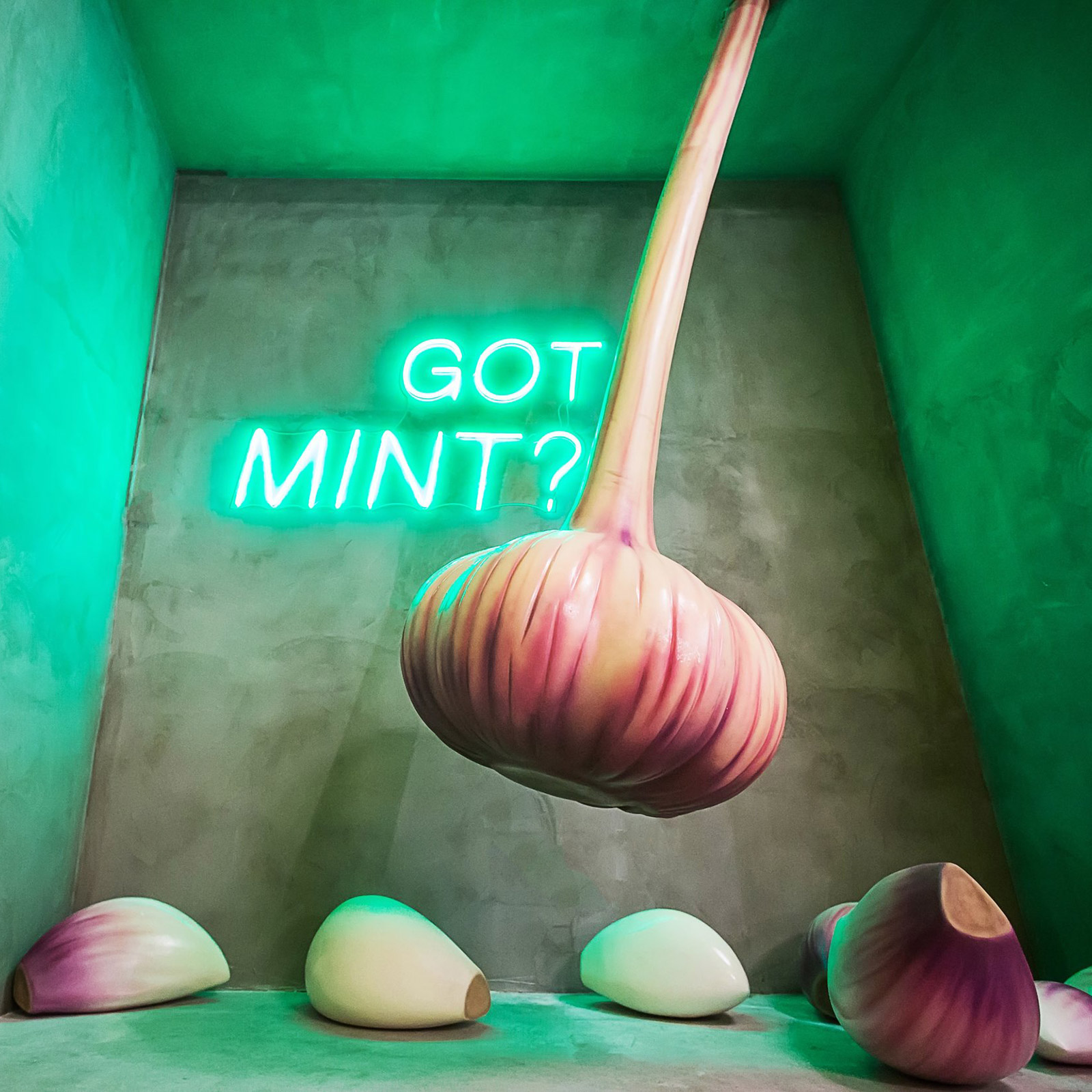 green walls behind a garlic swing in a dumpling pop up experience