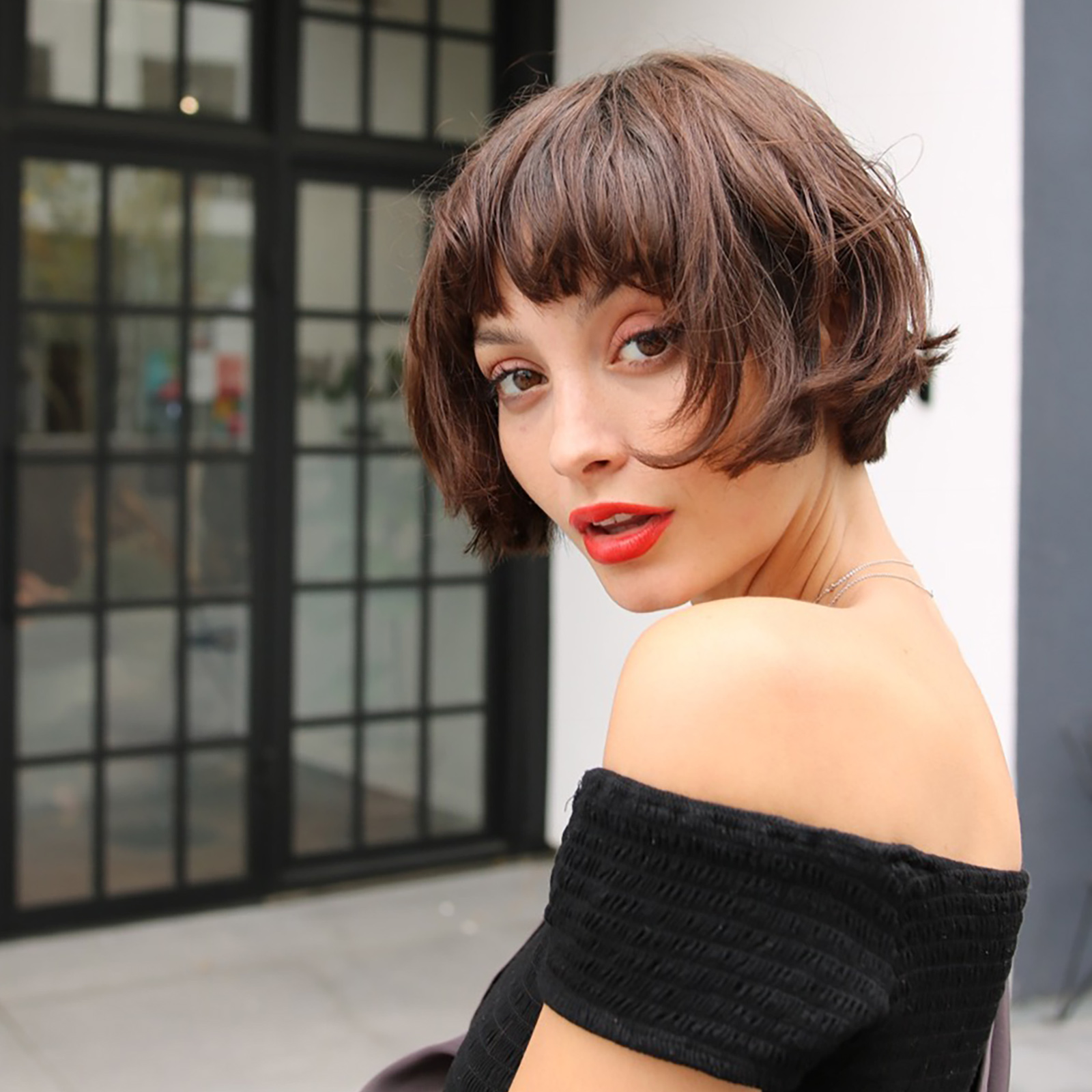 woman with short hair cut and fringe with red lipstick on