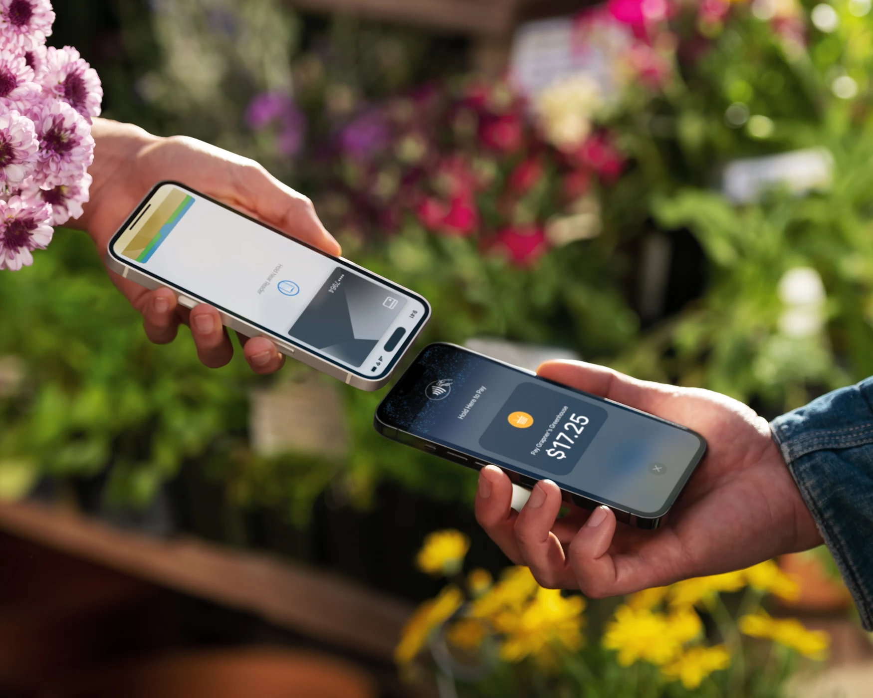 Customer paying for items in flower shop by tapping their credit card on the merchant's iPhone that's using Tap to Pay.