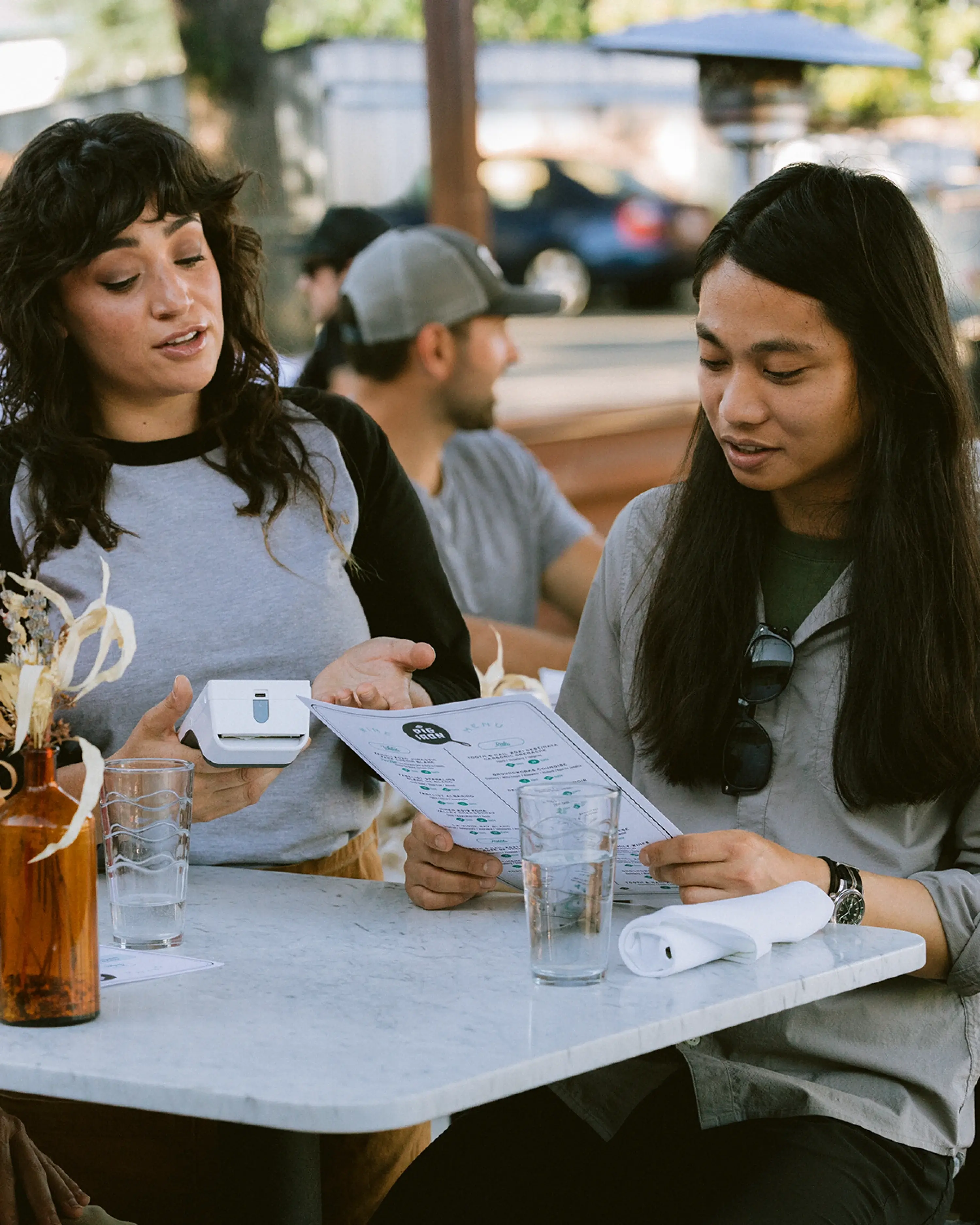 Waitress with Clover Flex discusses menu with restaurant guest
