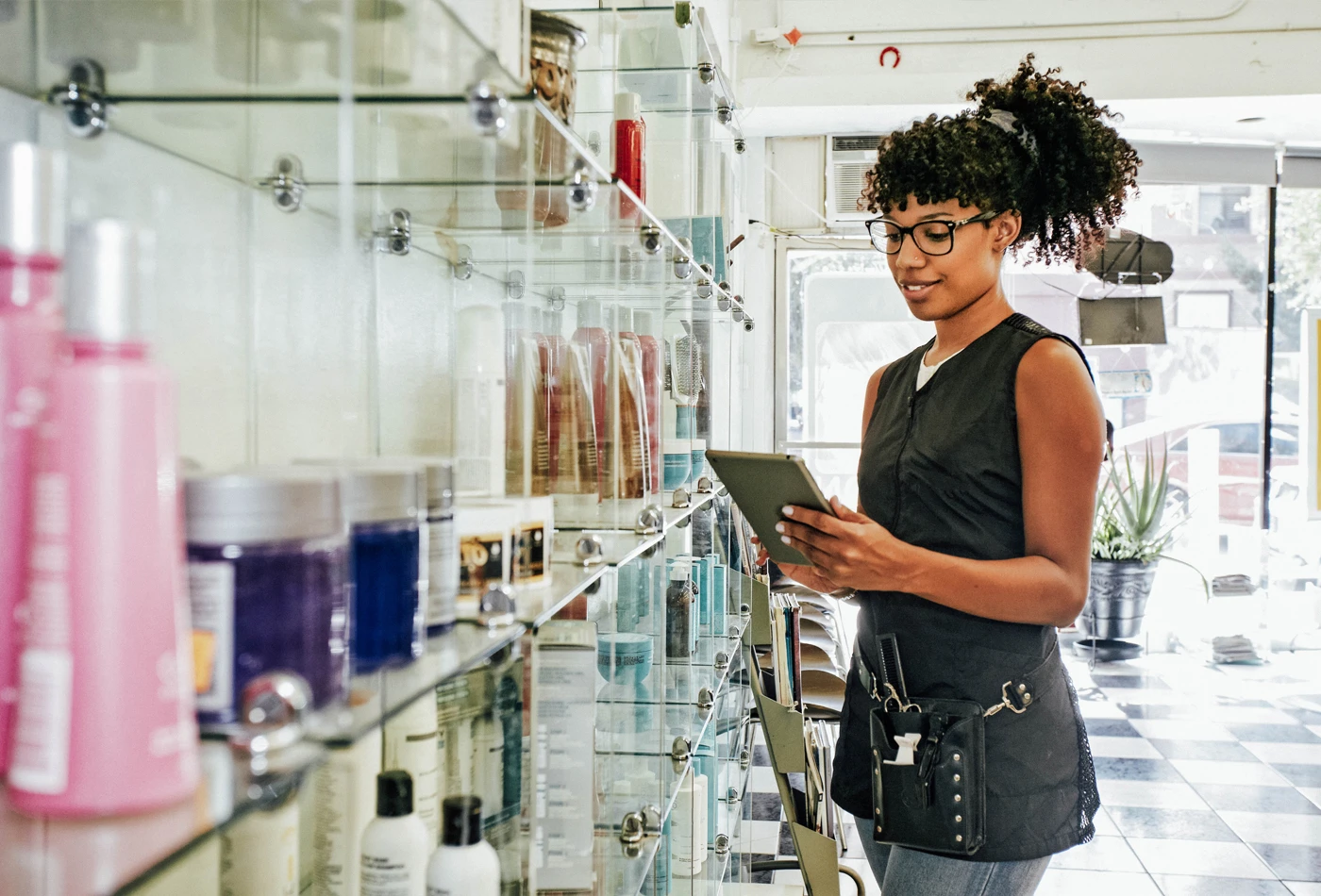 Woman with a tablet in hand at a hair salon
