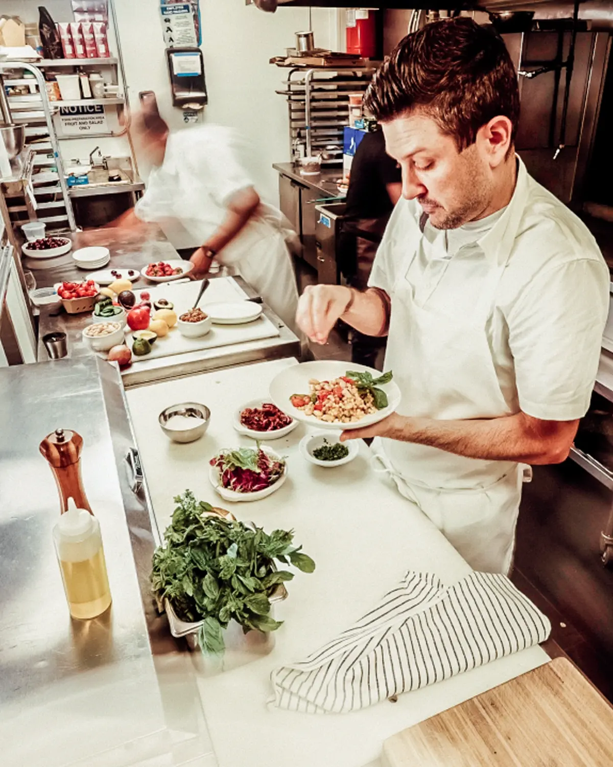 Image of a chef in a kitchen preparing a meal.