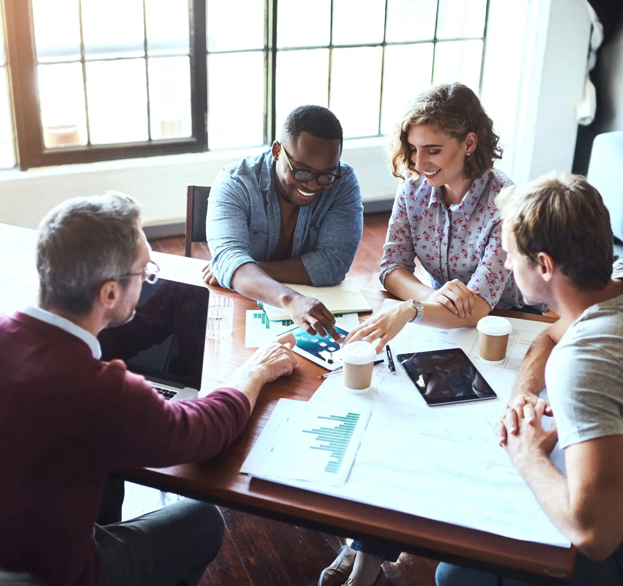 Four employees sitting at a table in conversation