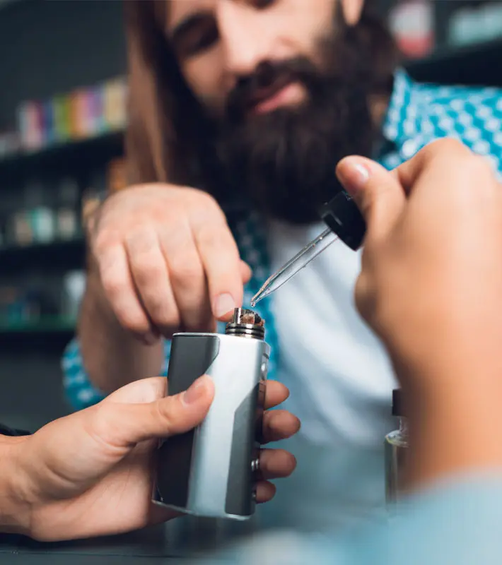 Person putting liquid into the vape