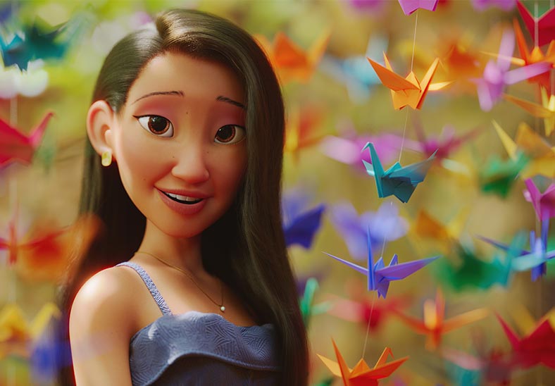 A woman in purple dress surrounded by colorful hanging origami birds.