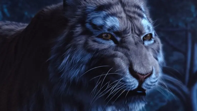 A growling tiger illuminated by a blue light in the darkness.