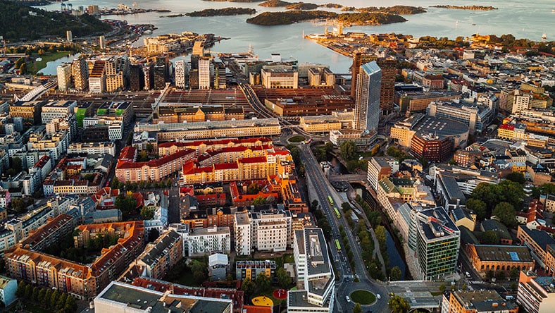 An aerial view of Oslo centers on downtown buildings and the shoreline.