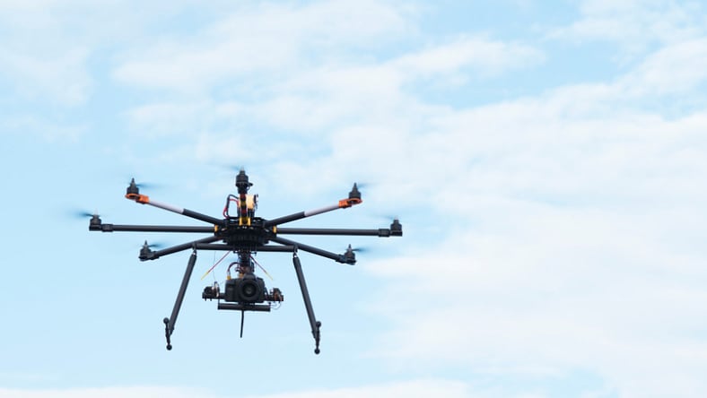 Drone in the air carrying SLR professional camera