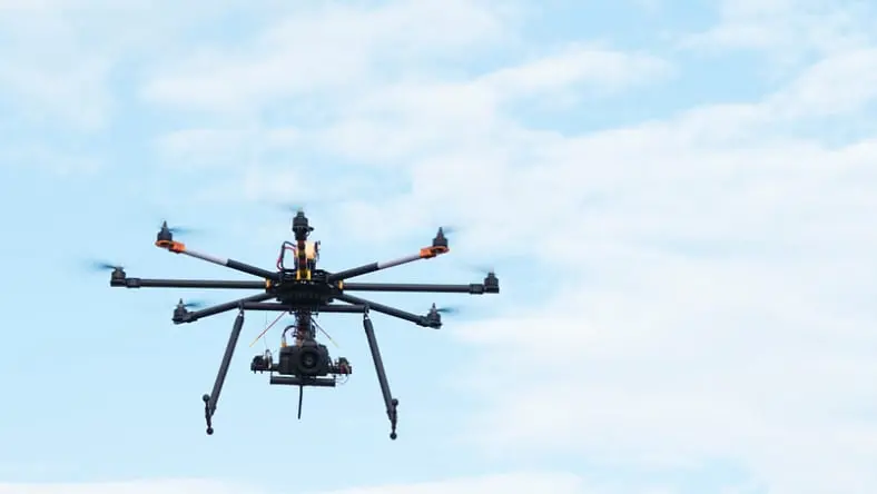 Drone in the air carrying SLR professional camera