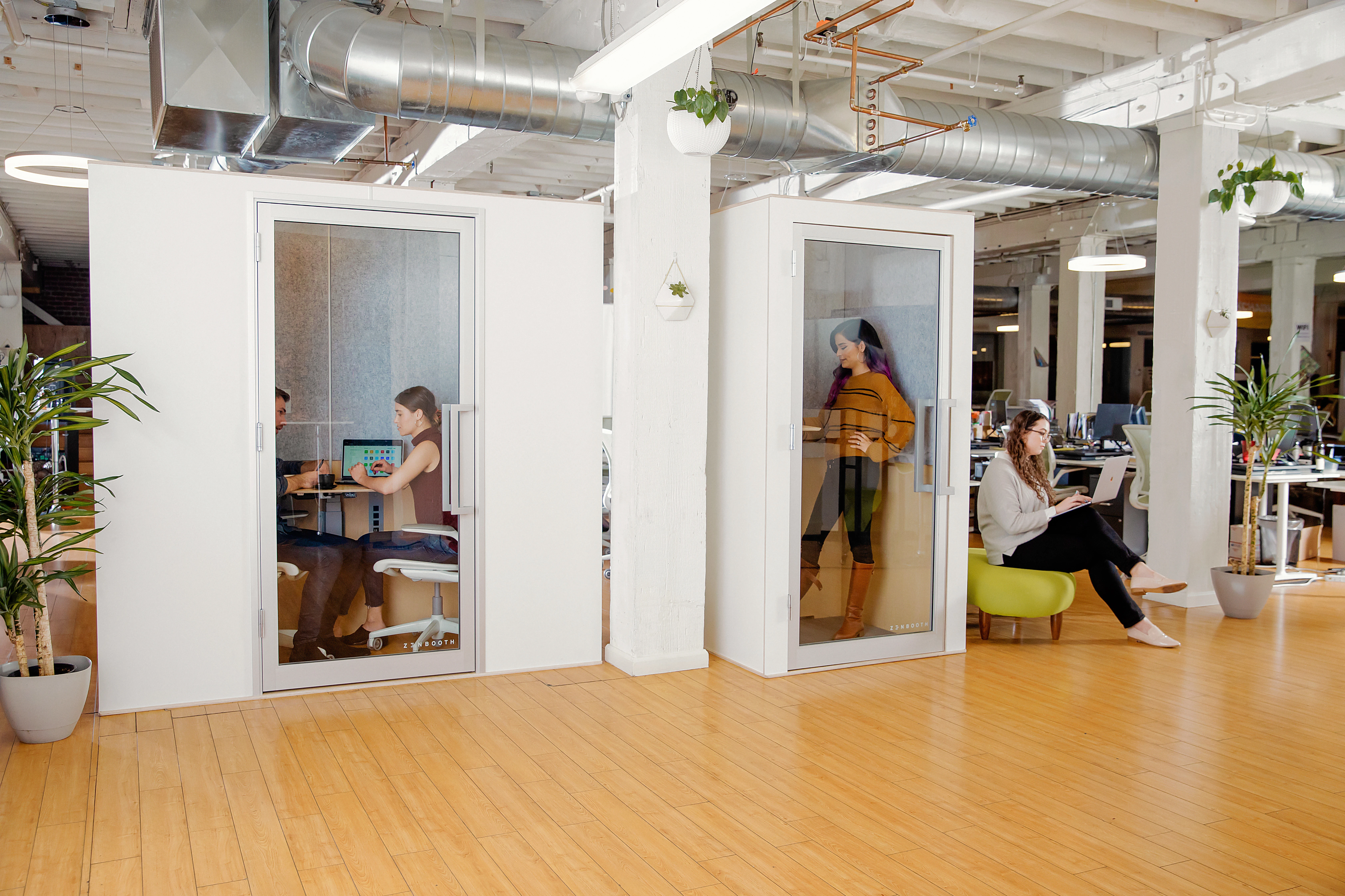 Photograph of Zenbooth privacy pods being used by employees in an office setting.