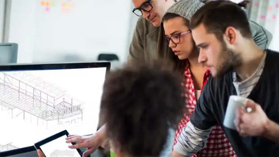 Designers reviewing a computer model on a screen