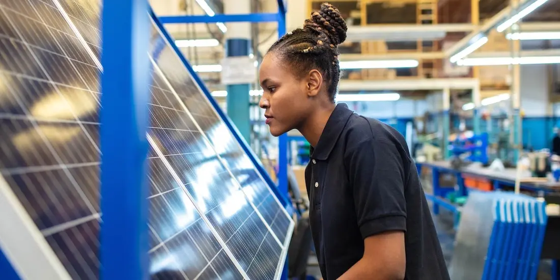 woman working on solar panel