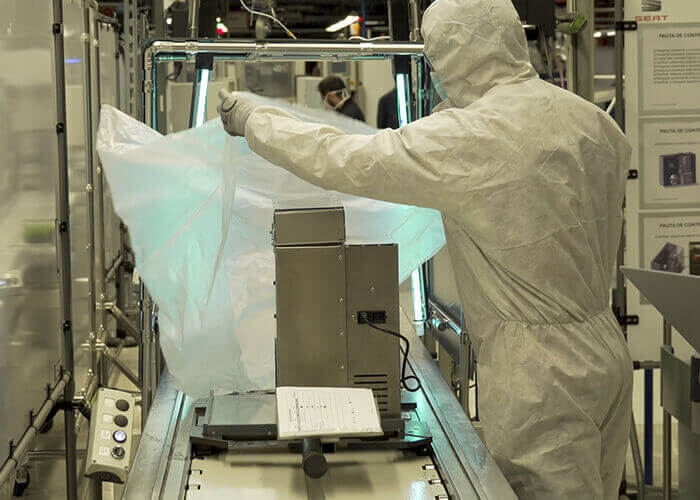 Ventilator production worker in protective gear Seat assembly line