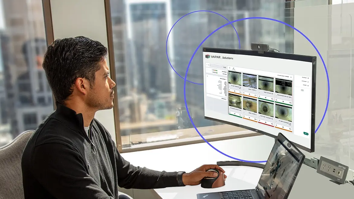 An engineer is working at the desktop on the info360 software