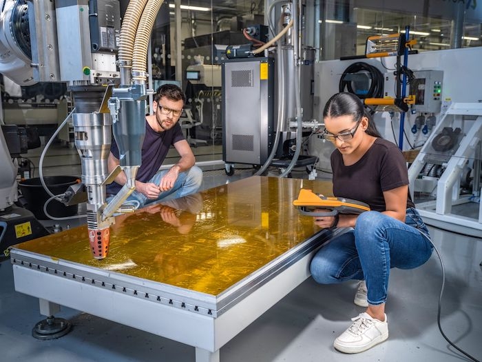 man and woman working with robotics