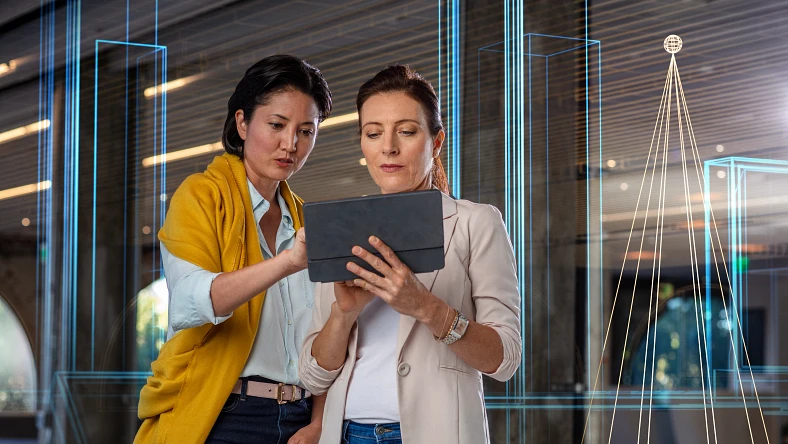 Designers looking at 3D model on a tablet