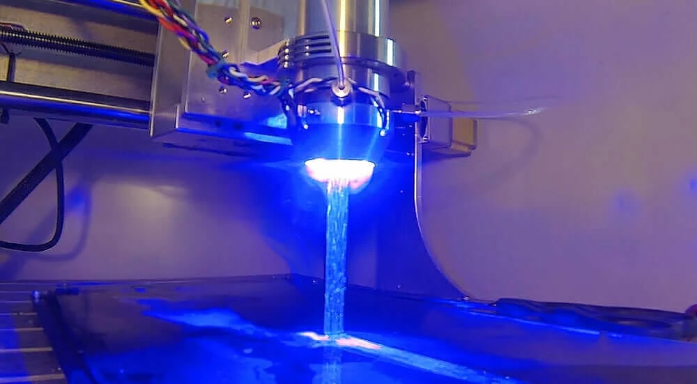 A UV light glows blue in Continuous Composites' 3D-printing process.