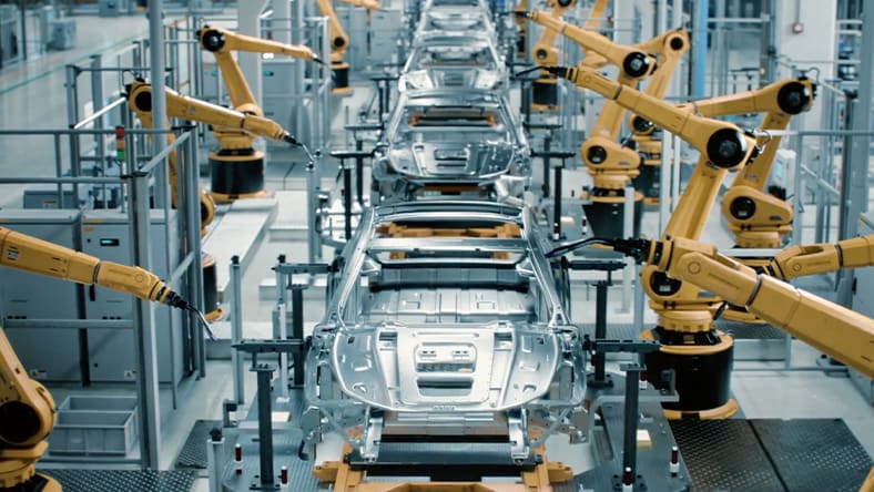 Robots assembling vehicles in factory line