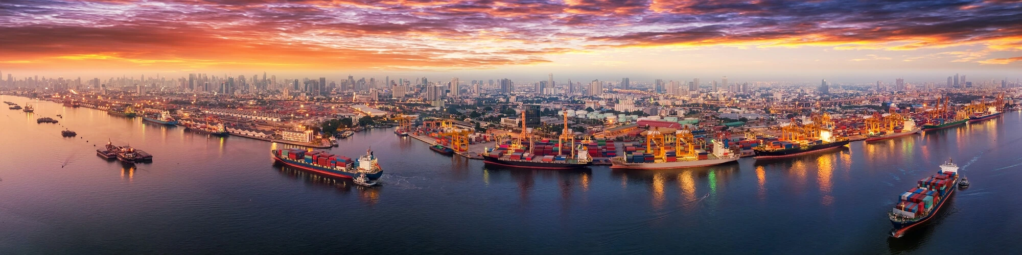 A city port glows at sunset
