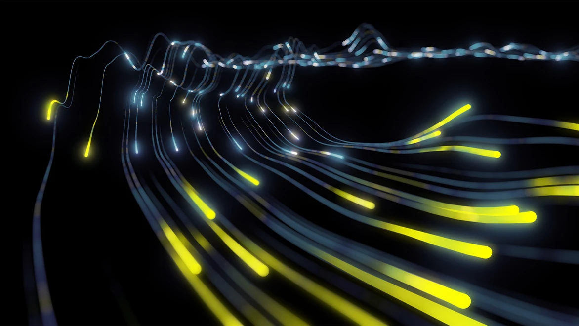 Glowing yellow and blue light trails flowing across a black background.