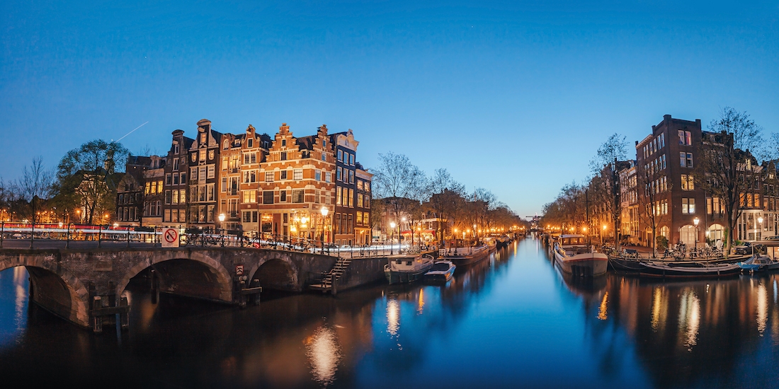 Amsterdam canal houses and bridges at night