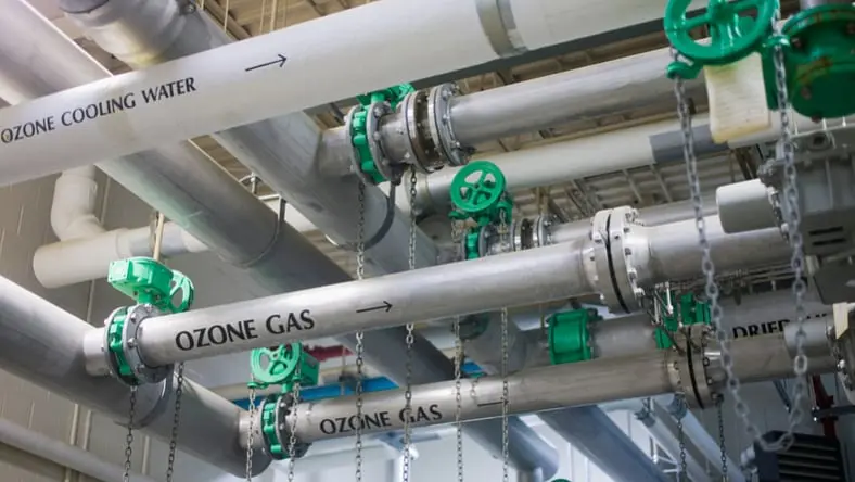 Interior view of pipes and valves at a water treatment facility