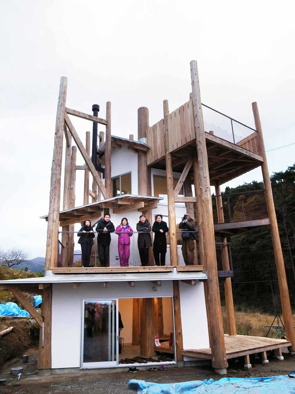 Toyo Ito and fellow architects at a Home-for-All building in Rikuzentakata, Japan