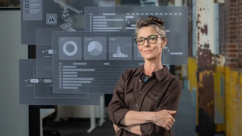 Woman with PLM software workflows displayed on screens behind her