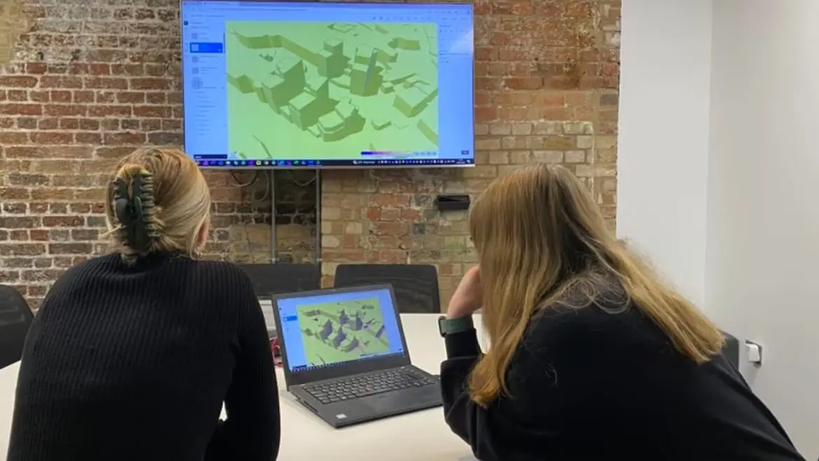 Two architects reviewing a 3d model.