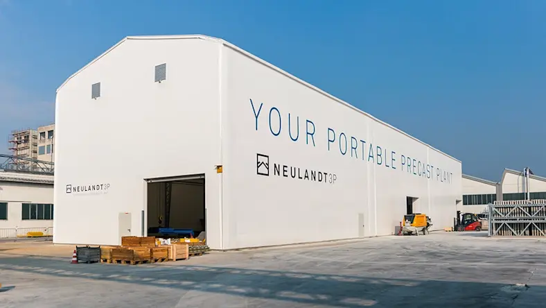 Building affordable housing: Today, Austria; tomorrow, Africa: NEULANDT’s 3P portable precast plant is 230 feet (70 meters) long and 49 feet (15 meters) wide.